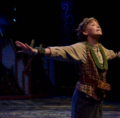 An actor with arms stretched out from Peter Pan