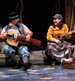 Two actors onstage playing instruments
